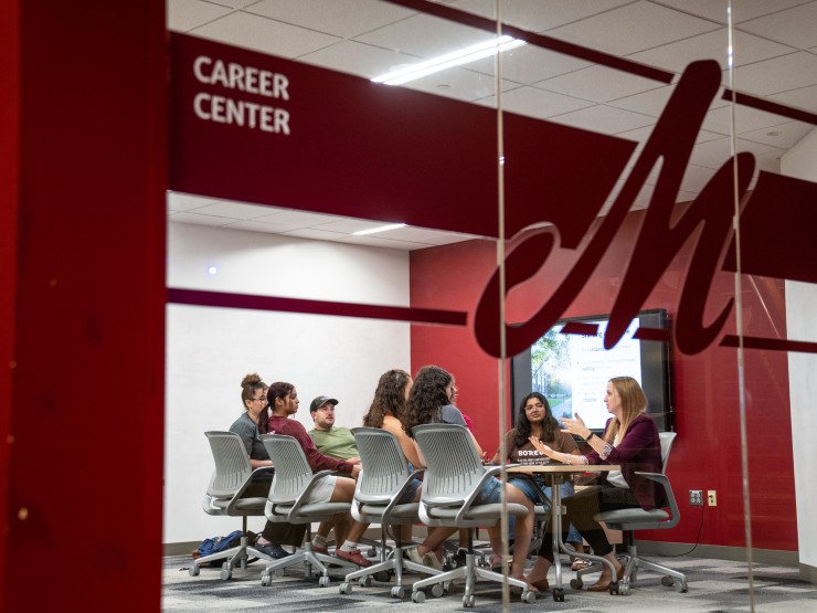 Caitlin Bach, assistant director of career coaching & education, works with students in the Career Center.